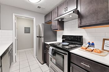 a kitchen with stainless steel appliances and a refrigerator at Waldan Pond Apartments, Acworth, GA, 30102